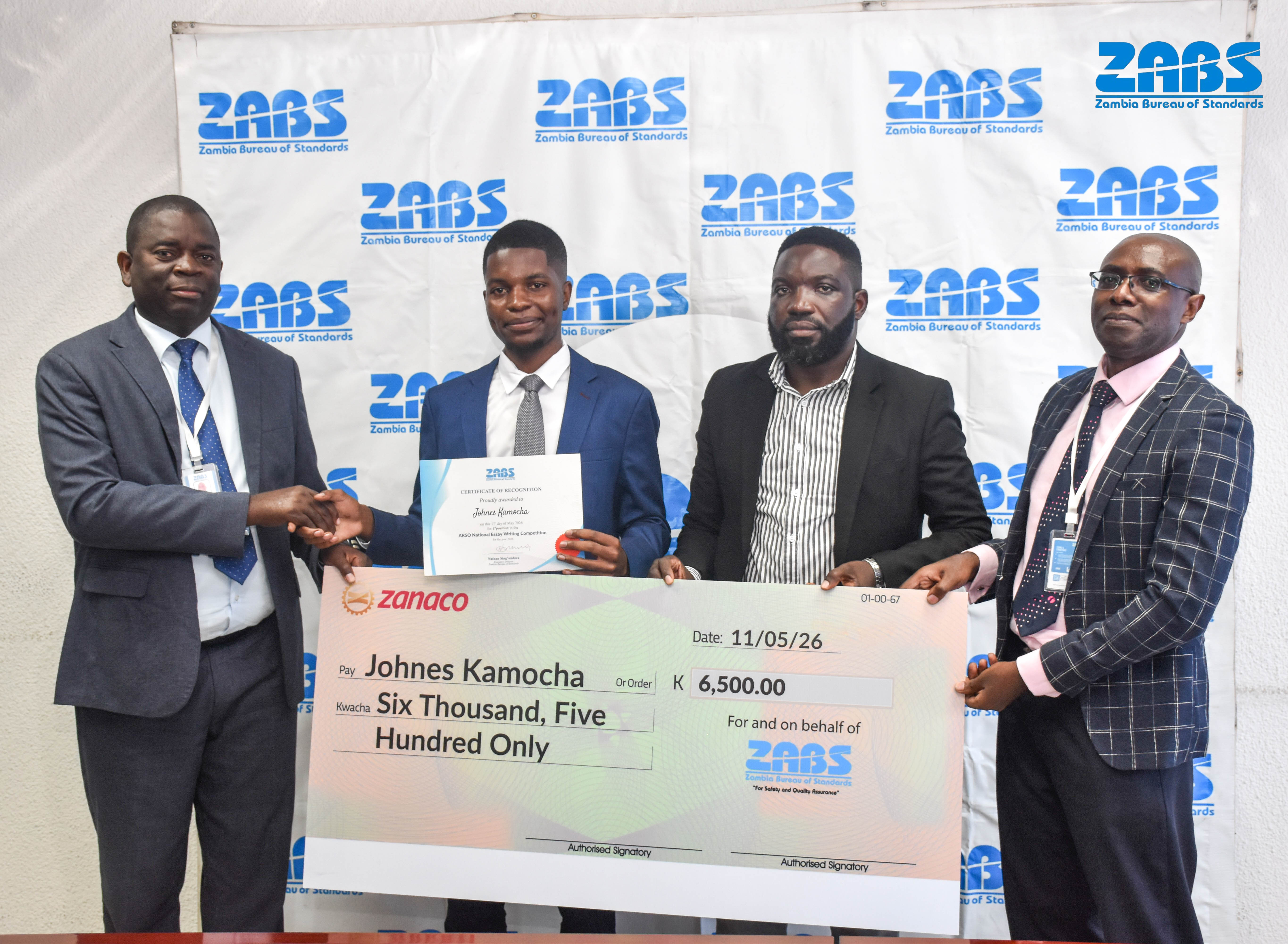 Winner receiving a prize cheque during the essay competition awards event.