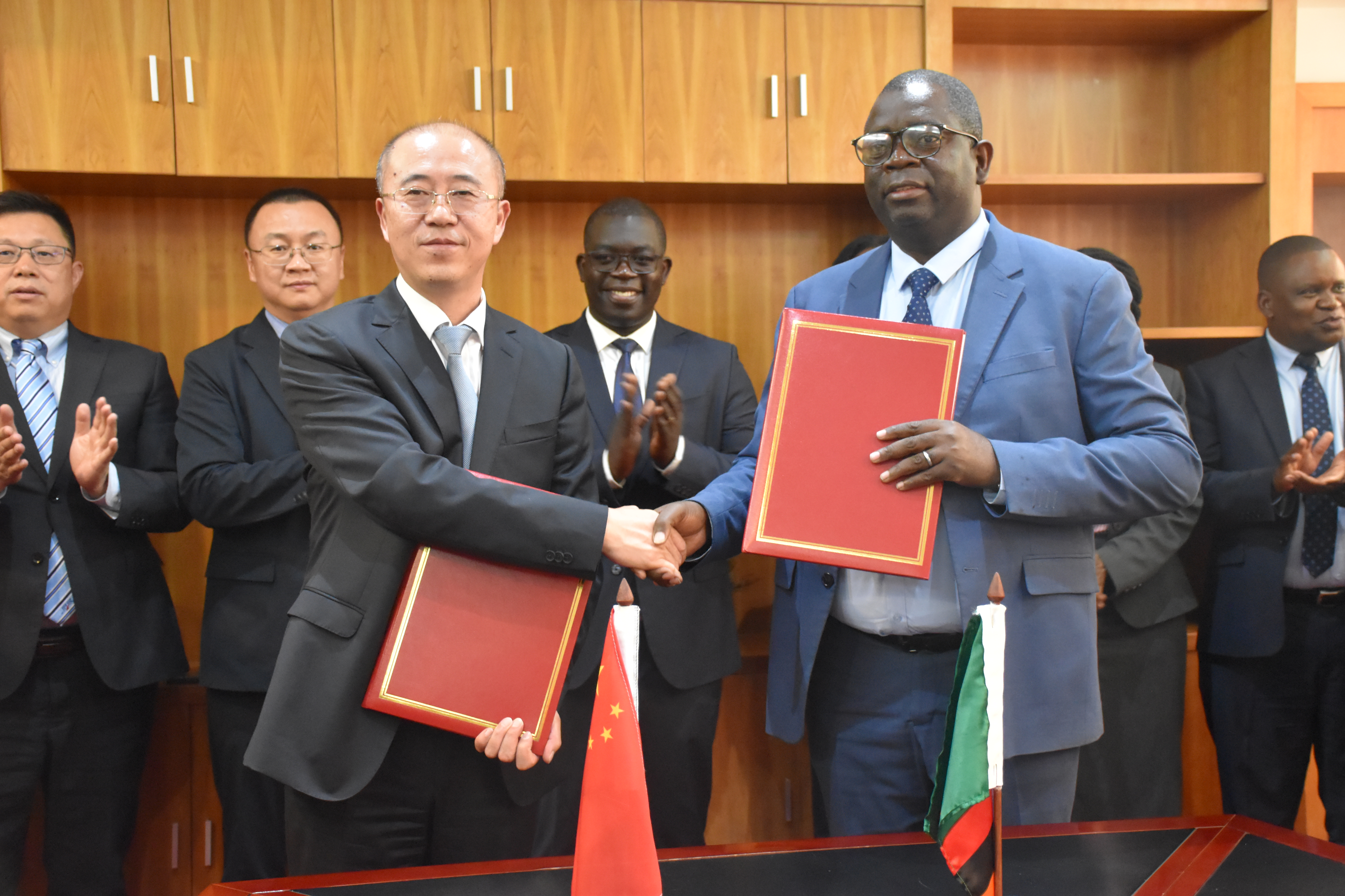 Formal signing ceremony between ZABS and an international counterpart.