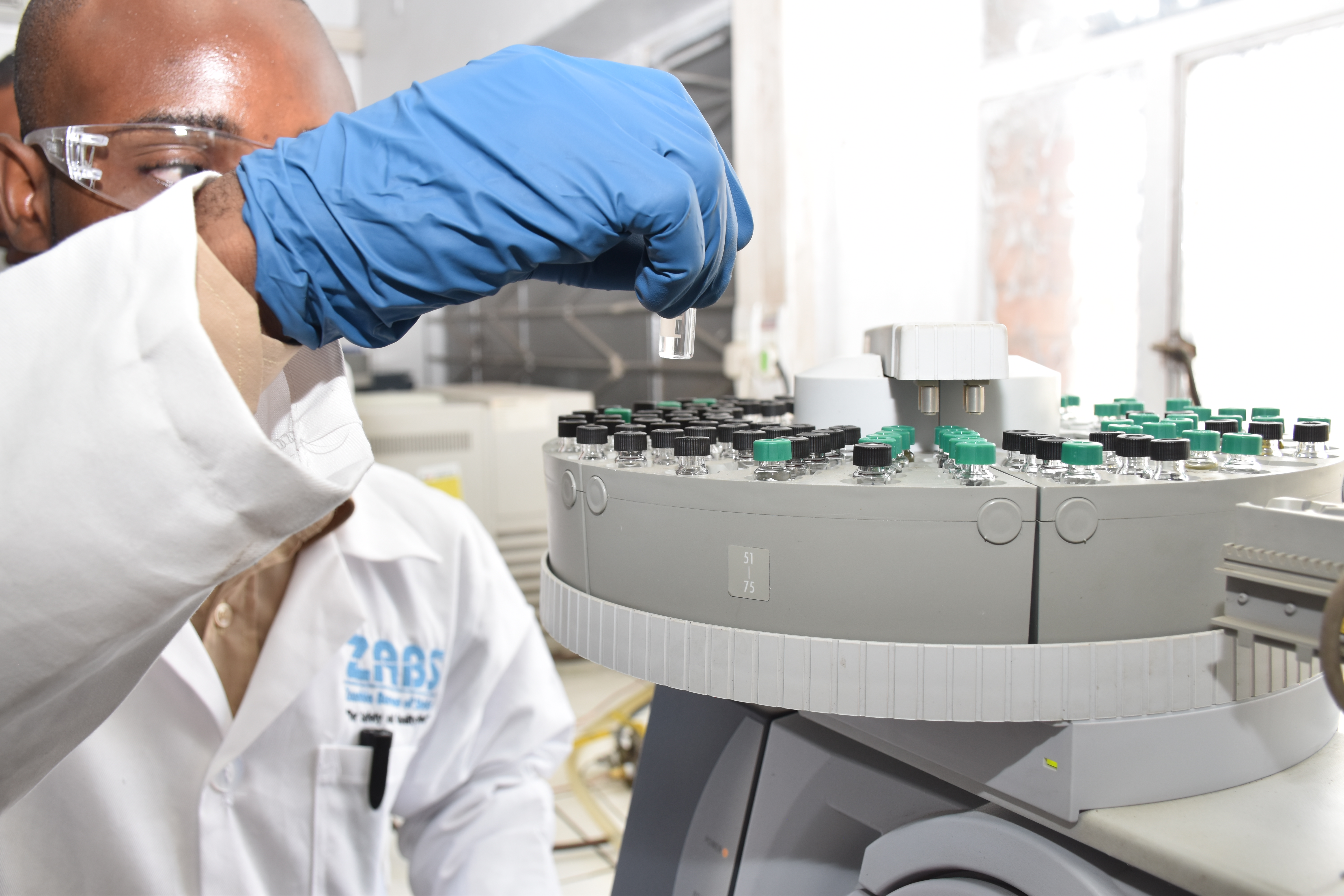 Laboratory analyst working with automated testing equipment at ZABS.